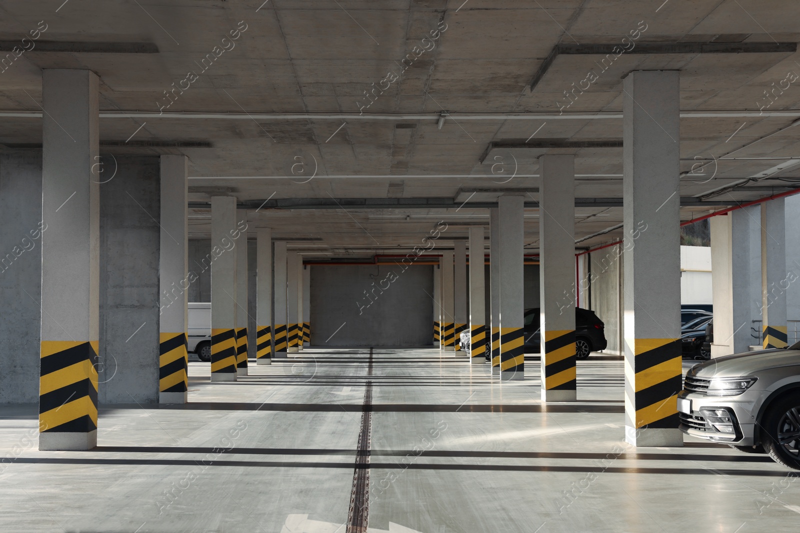 Photo of Open parking garage with cars on sunny day