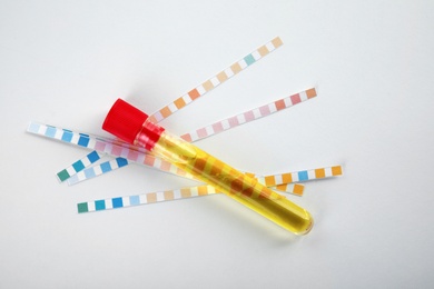 Photo of Test tube with urine sample for analysis on white background, top view
