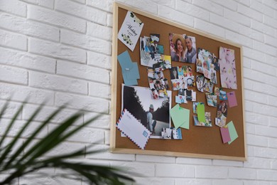Photo of Vision board on white brick wall indoors