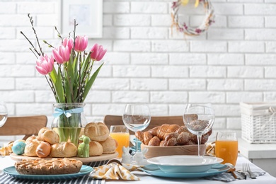 Photo of Festive Easter table setting with traditional meal at home