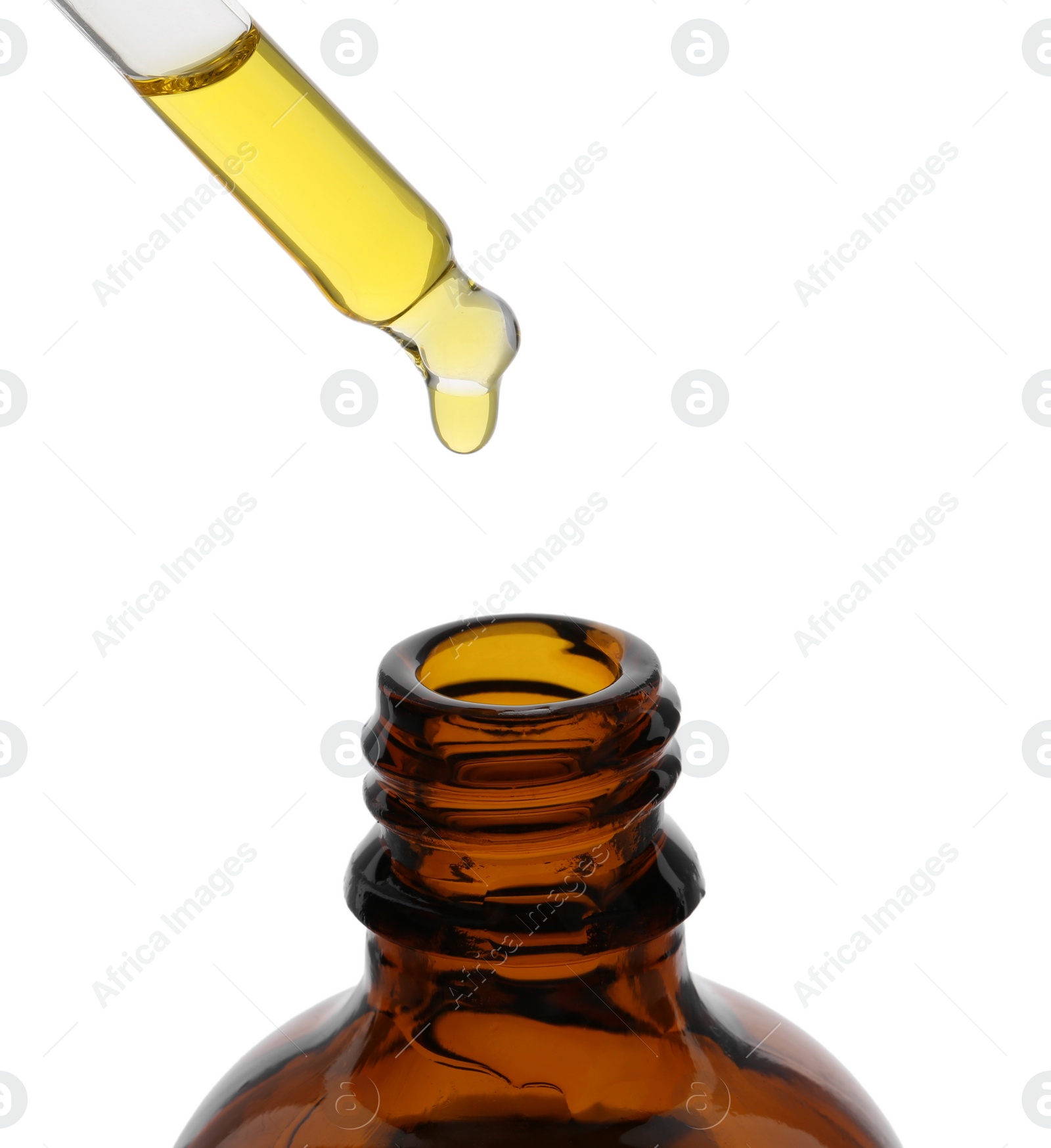 Photo of Dripping tincture from pipette into bottle isolated on white