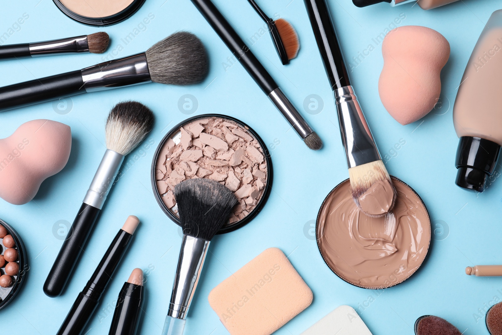 Photo of Flat lay composition with skin foundation, powder and beauty accessories on color background