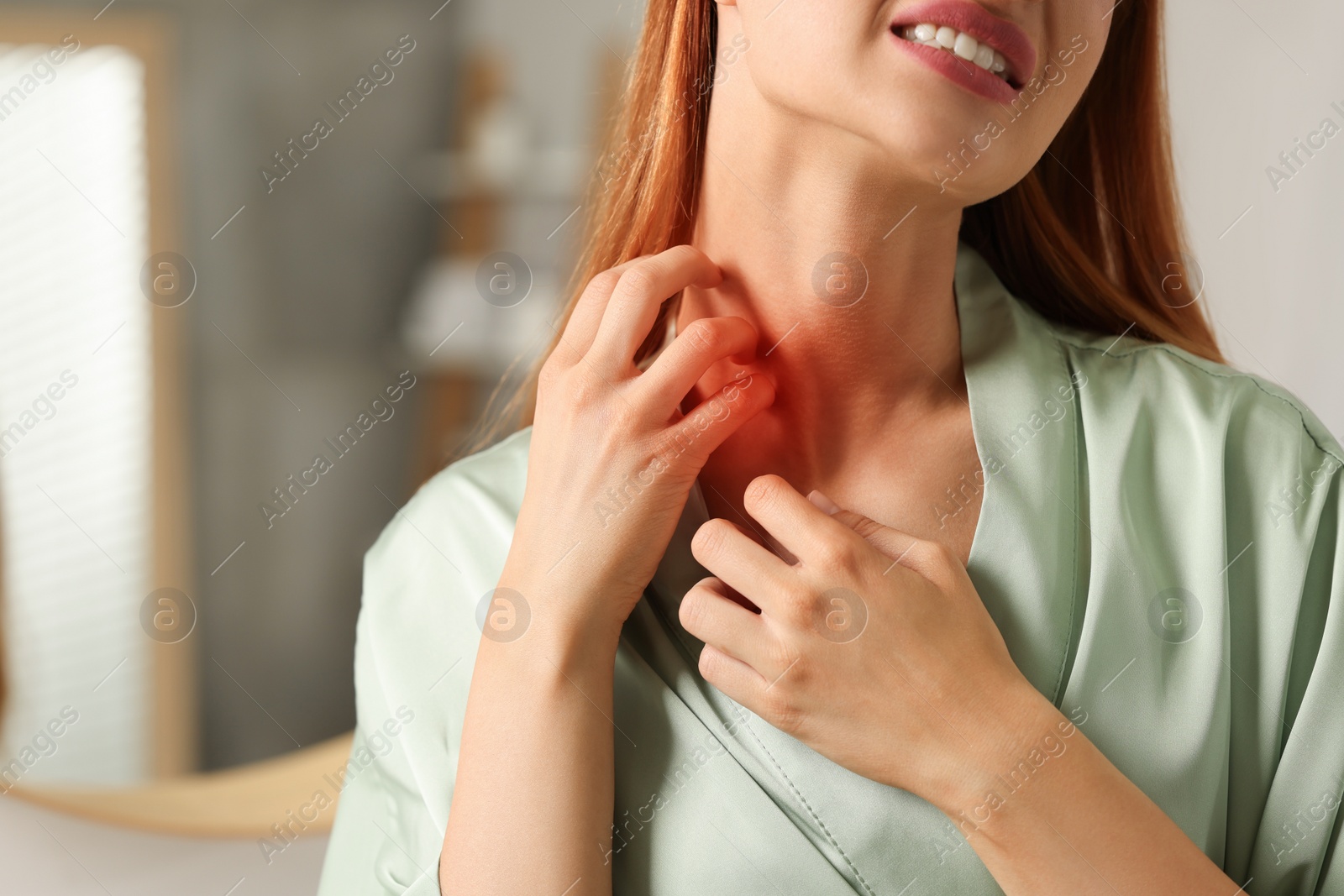 Photo of Suffering from allergy. Young woman scratching her neck in bathroom, closeup. Space for text