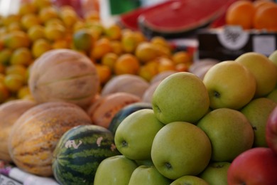 Photo of Different fresh ripe fruits on counter at market, closeup