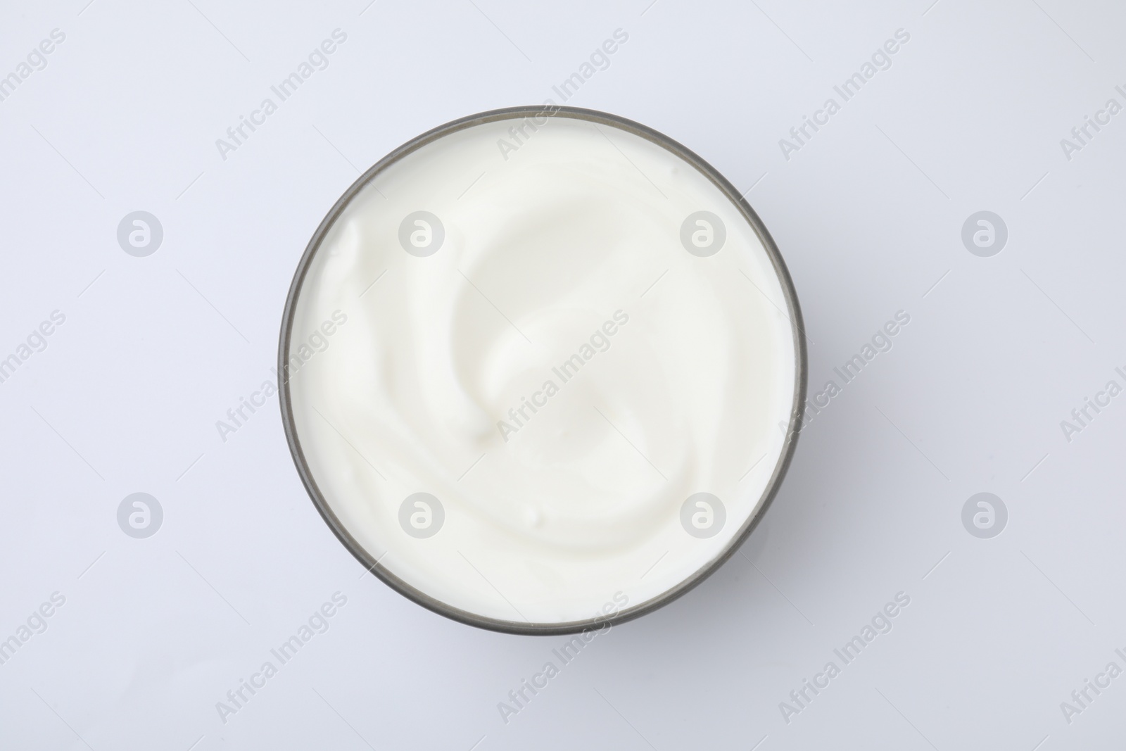 Photo of Delicious natural yogurt in bowl on white background, top view