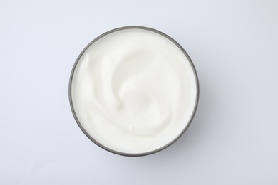 Photo of Delicious natural yogurt in bowl on white background, top view