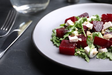 Delicious beet salad served on black table, closeup