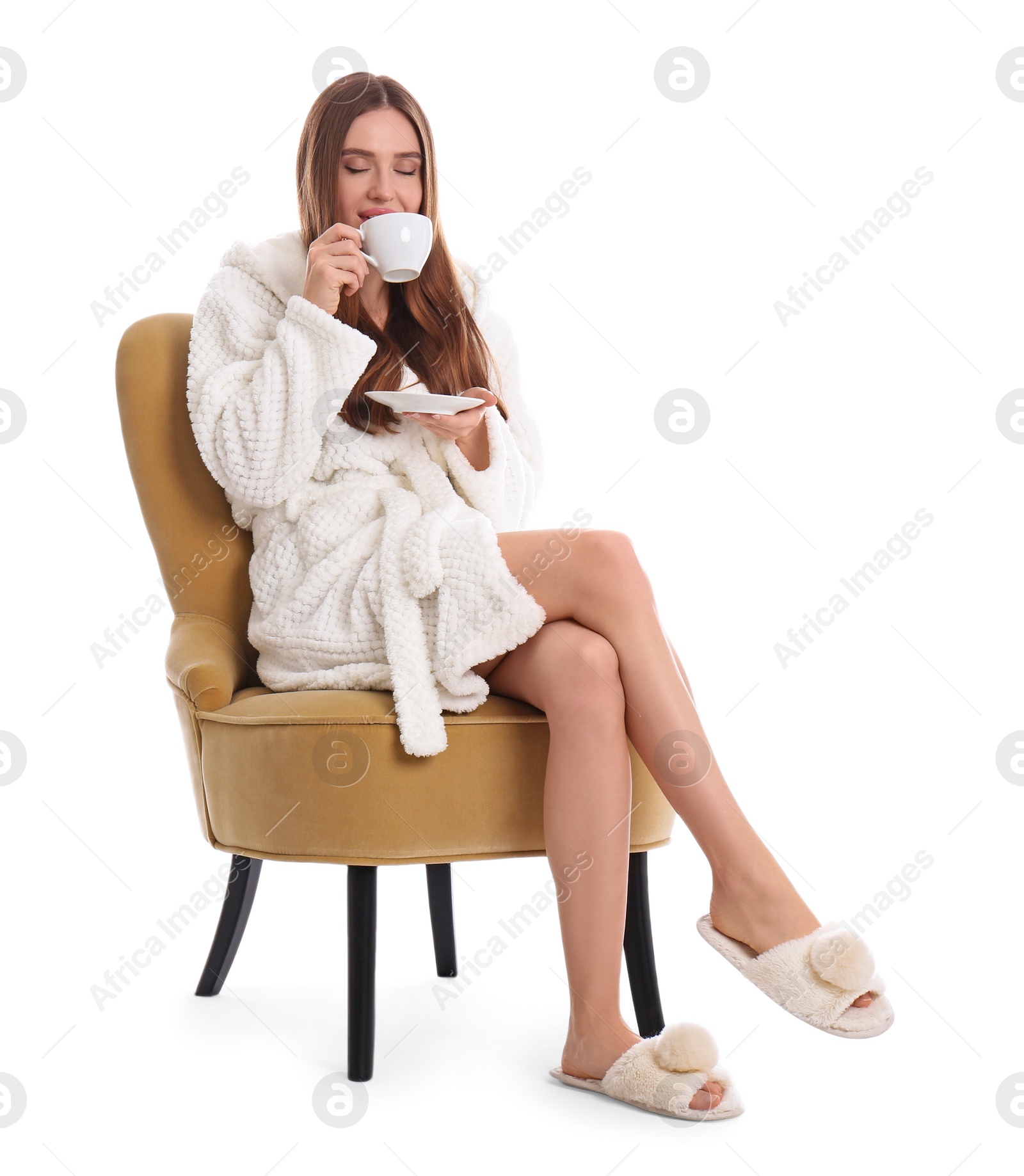 Photo of Young woman in bathrobe with cup of drink on white background