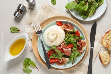 Photo of Delicious burrata salad served on light grey marble table, flat lay