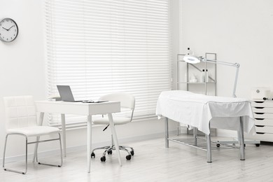 Modern interior of dermatologist's office with examination table