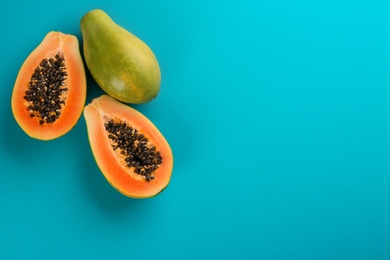 Fresh ripe papaya fruits on blue background, flat lay. Space for text