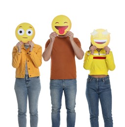 People covering faces with emoticons on white background