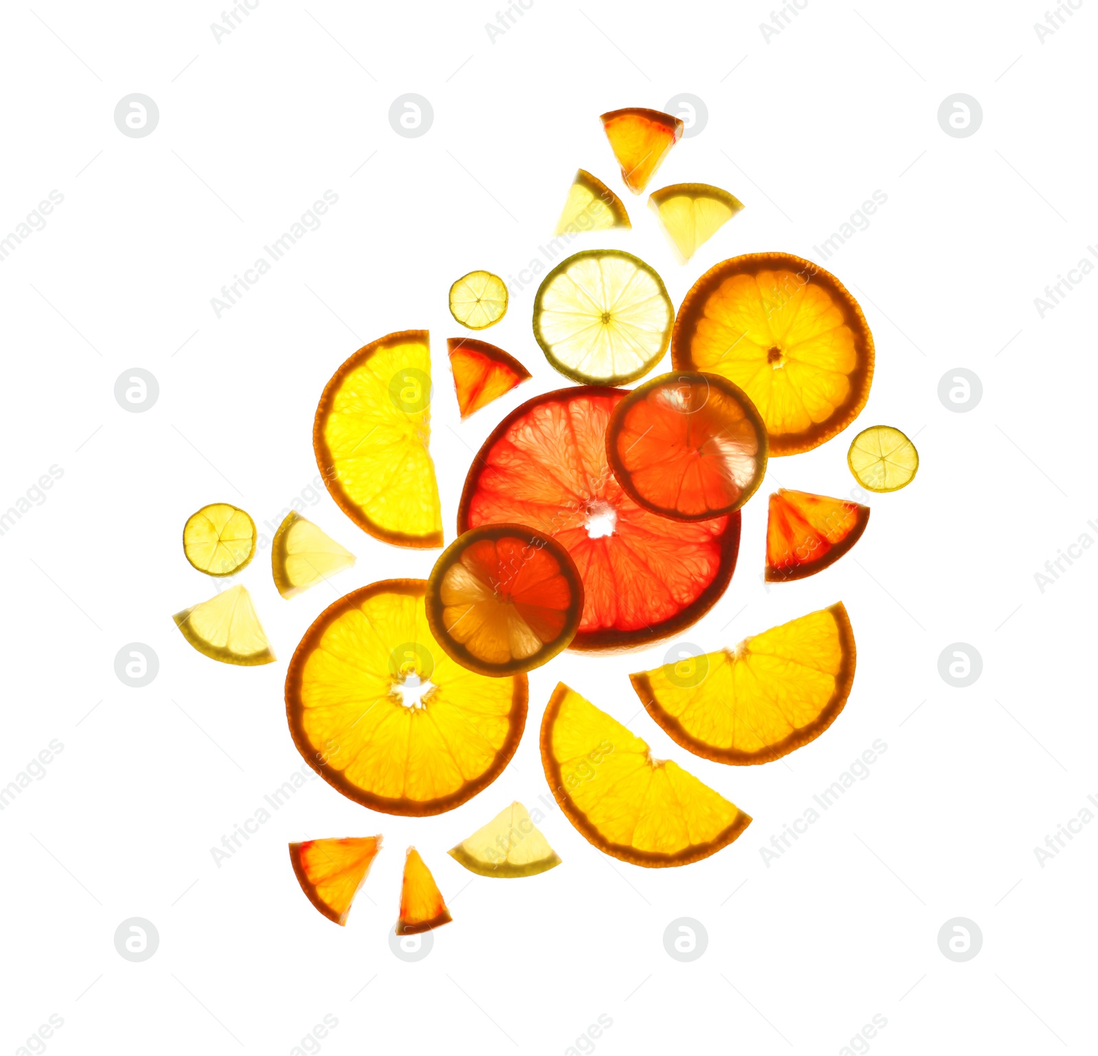 Photo of Illuminated slices of citrus fruits on white background, top view