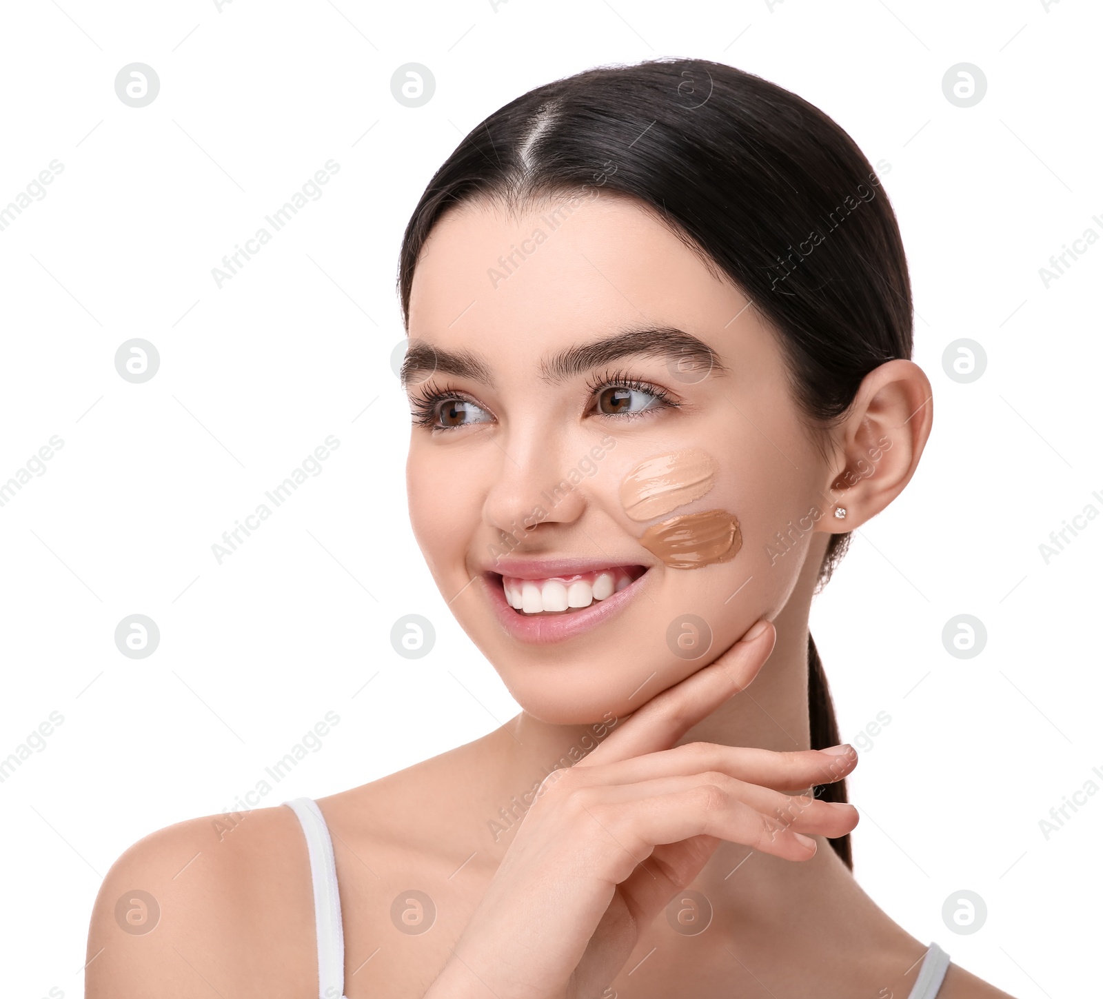 Photo of Teenage girl with swatches of foundation on face against white background