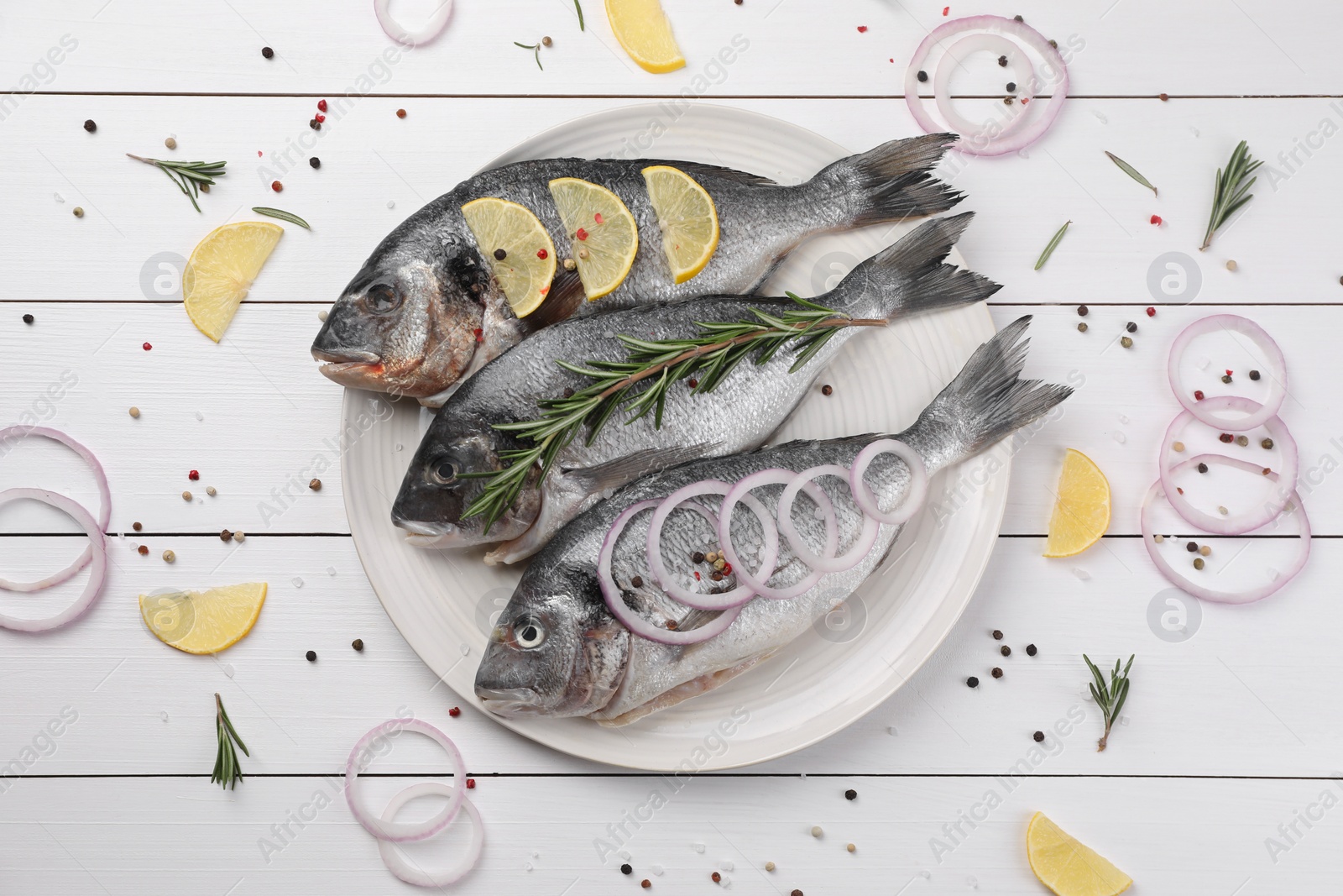 Photo of Flat lay composition with raw dorado fish and spices on white wooden table