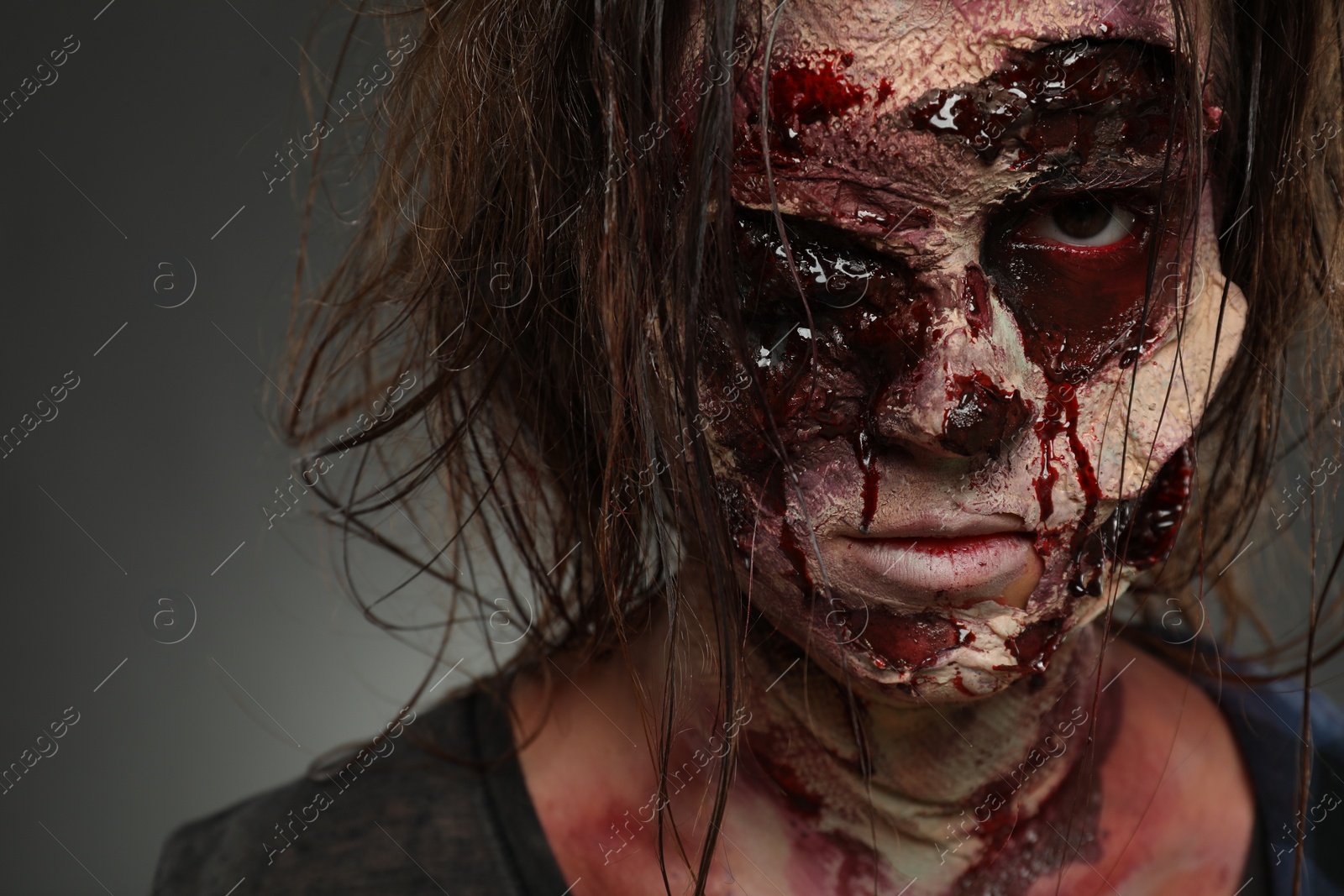 Photo of Scary zombie on dark background, closeup. Halloween monster