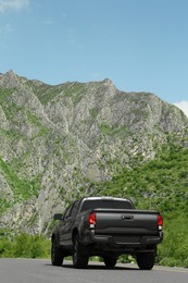 Black car on road near beautiful mountains outdoors