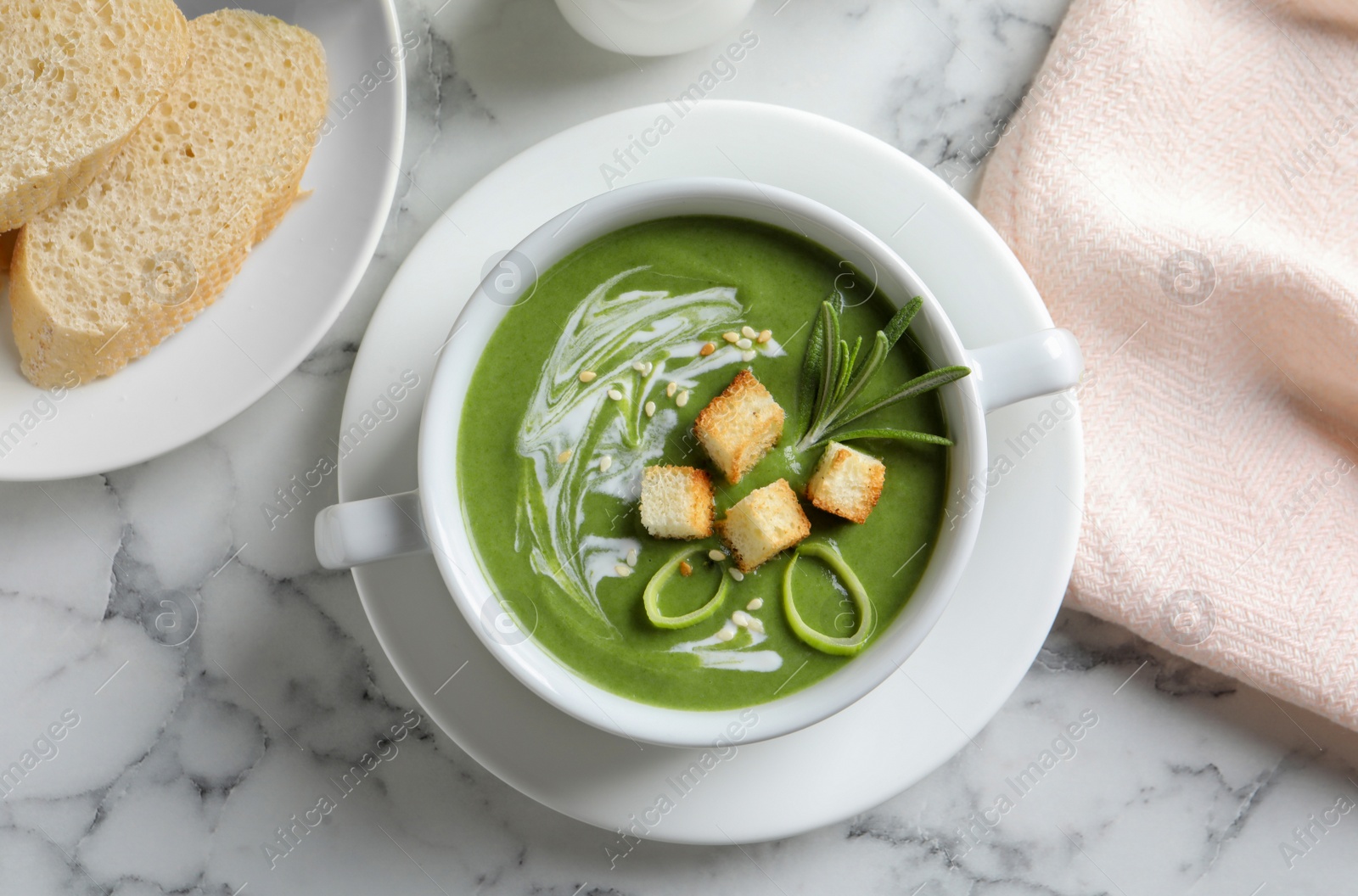 Photo of Fresh vegetable detox soup with croutons served on table, top view