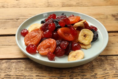 Mix of delicious dried fruits on wooden table, closeup