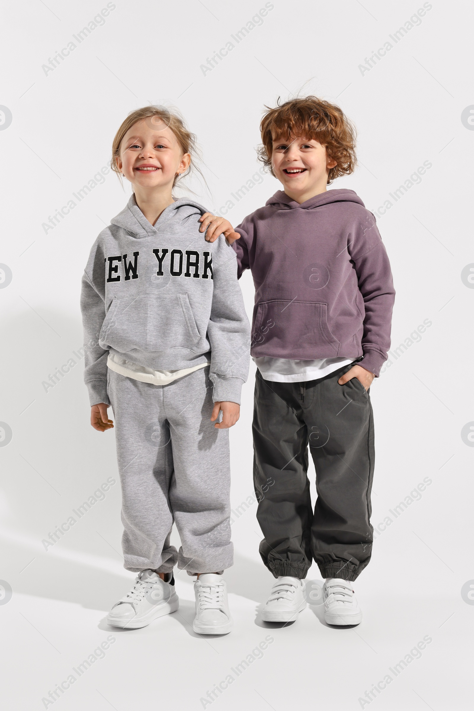 Photo of Fashion concept. Stylish children posing on white background