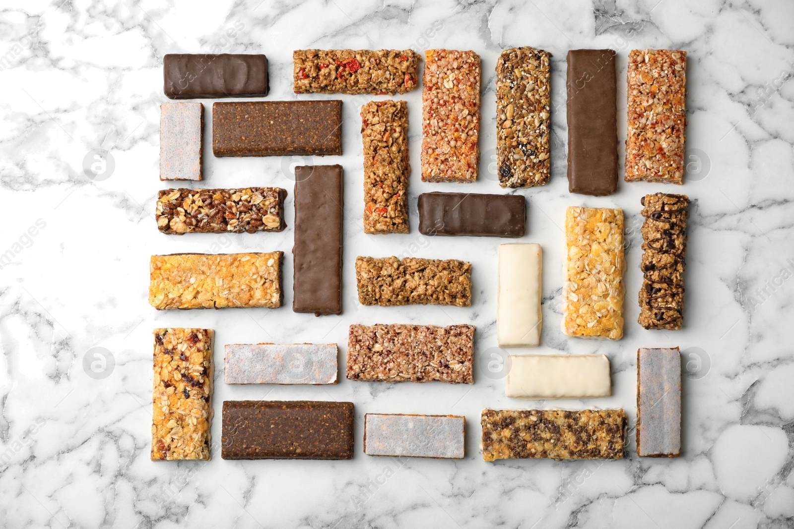 Photo of Flat lay composition with protein bars on marble background