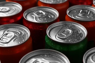 Photo of Energy drink in wet cans, closeup. Functional beverage