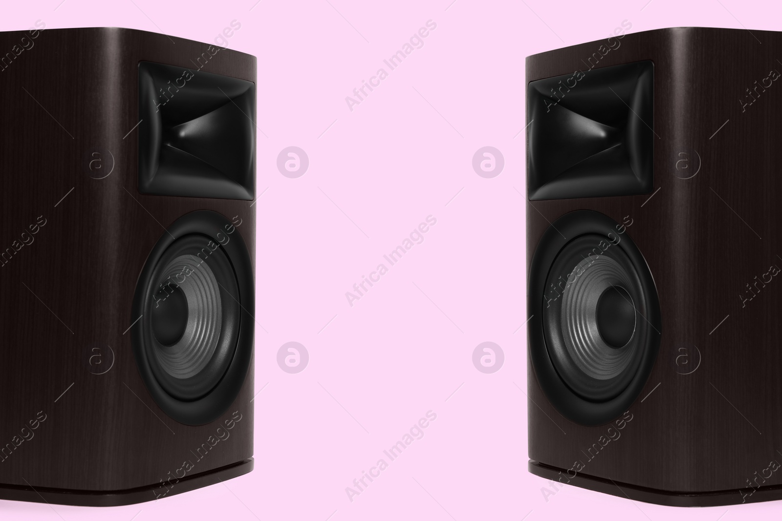 Photo of Wooden sound speakers on pink background. Space for text