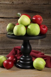 Fresh ripe red and green apples on wooden table