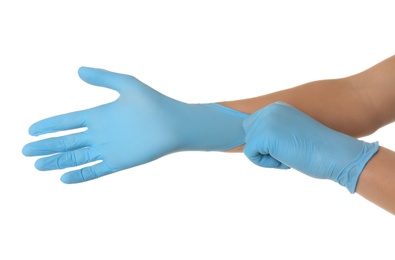 Person putting on blue latex gloves against white background, closeup