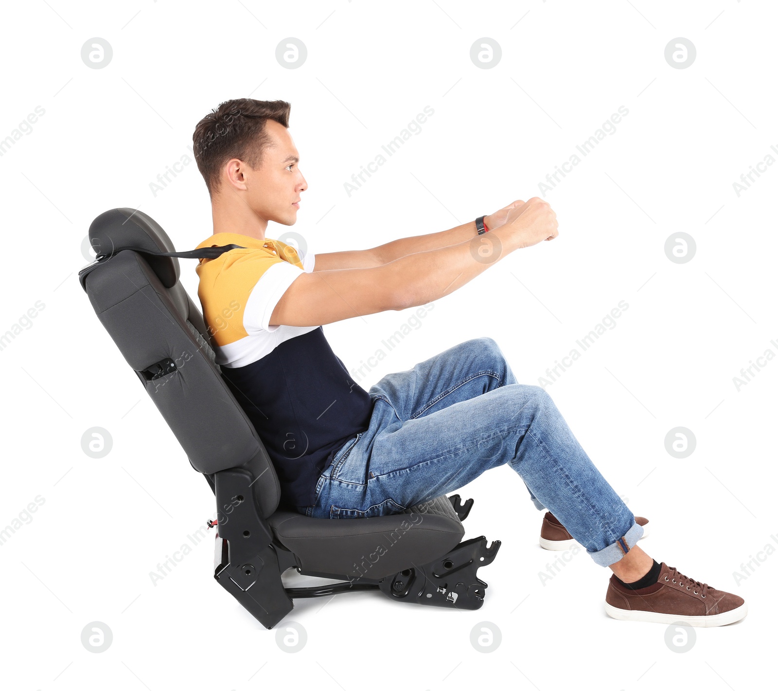 Photo of Young man sitting in car seat with safety belt on white background