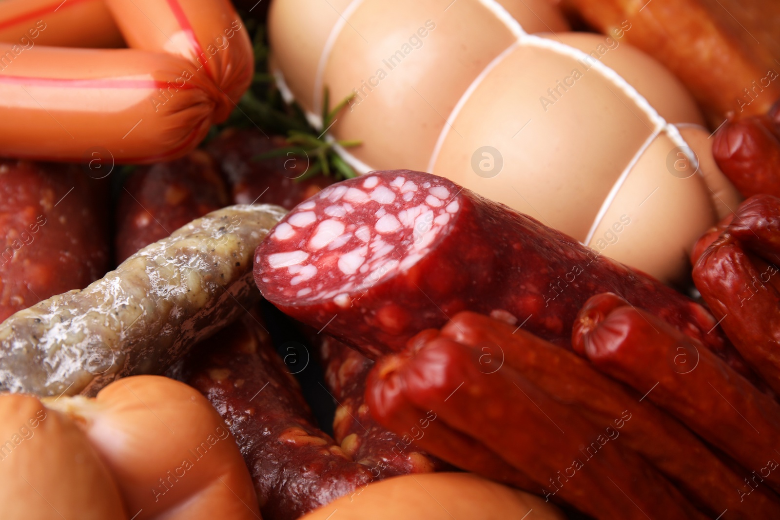 Photo of Different types of tasty sausages as background, closeup