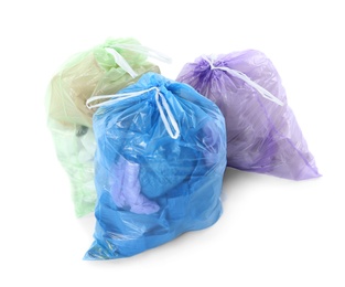 Photo of Full plastic garbage bags isolated on white