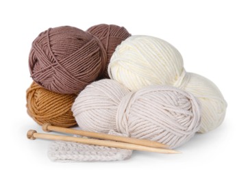 Photo of Soft woolen yarns, knitting and needles on white background