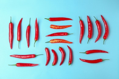 Photo of Flat lay composition with chili peppers on color background