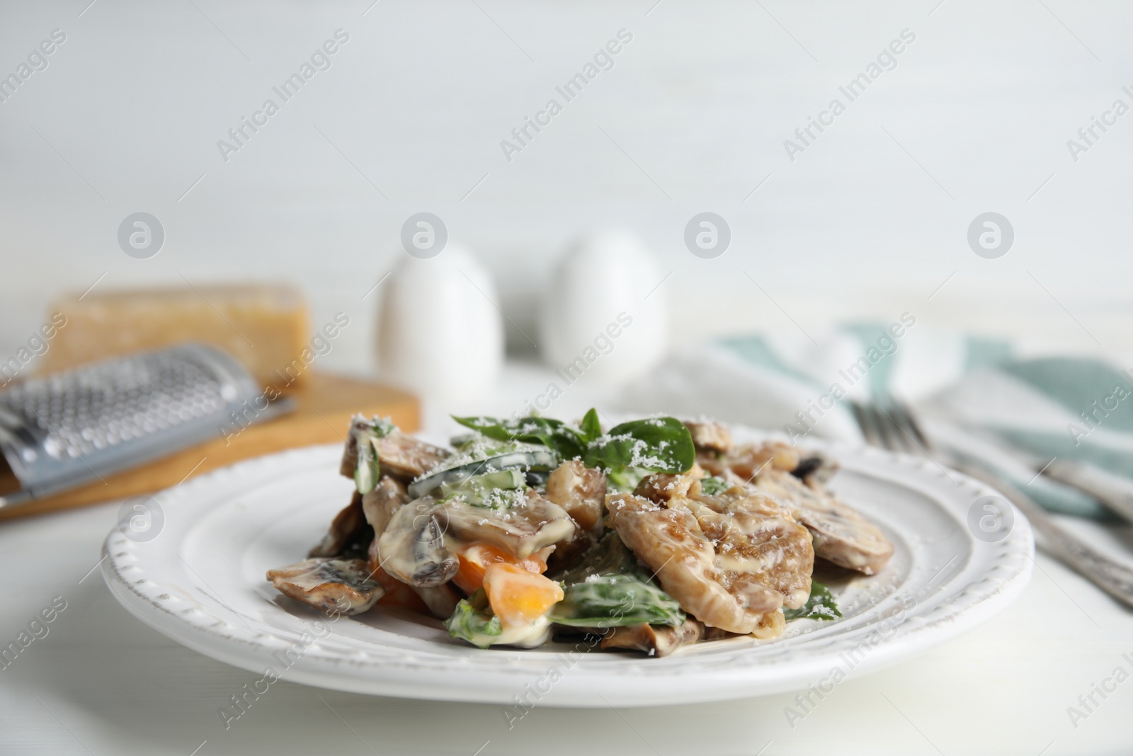 Photo of Delicious salad with mayonnaise on white table