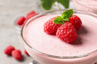 Glass of delicious raspberry mousse with mint, closeup