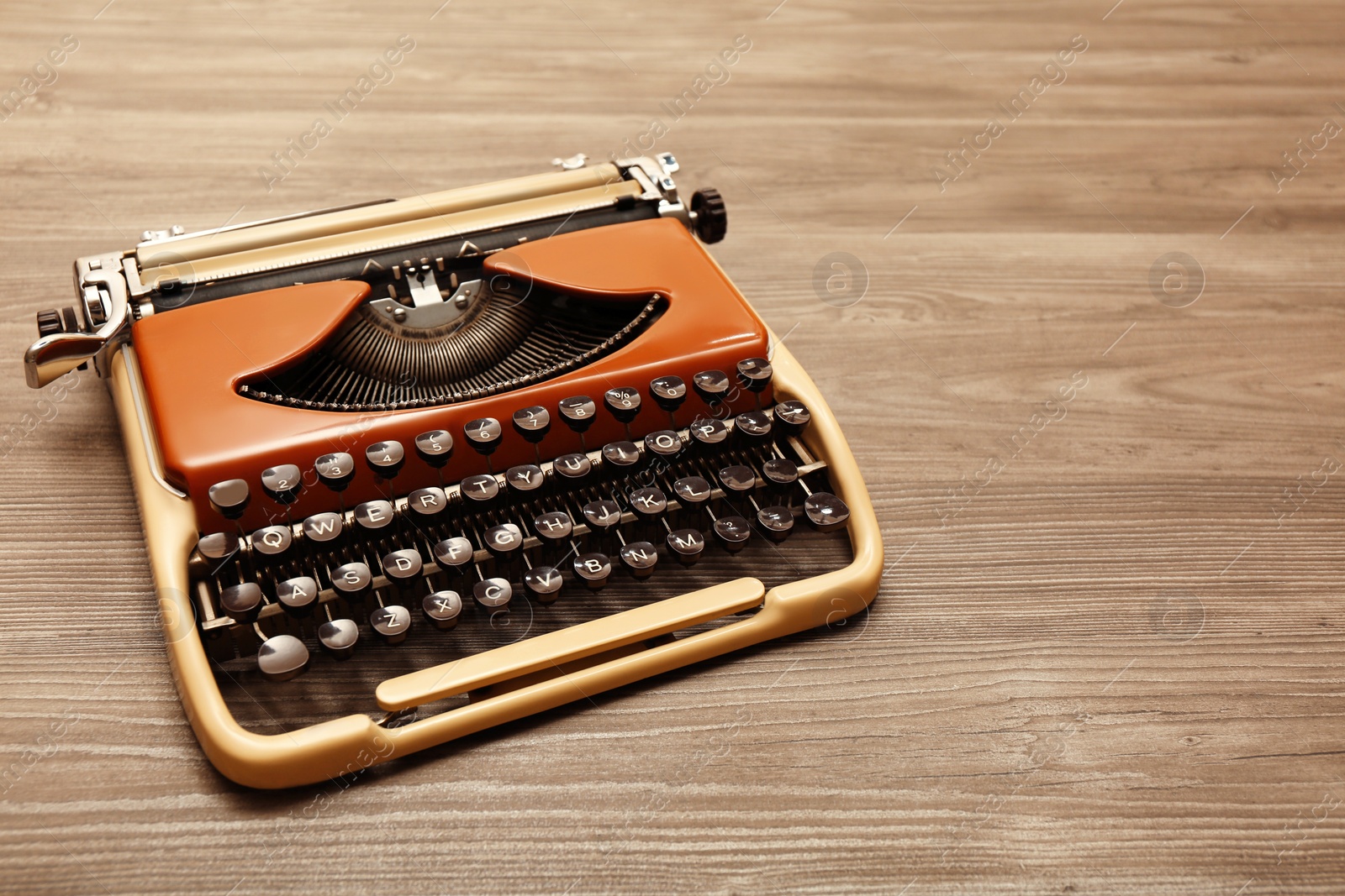 Photo of Vintage typewriter on wooden table. Space for text