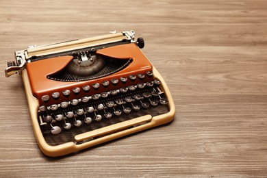 Vintage typewriter on wooden table. Space for text