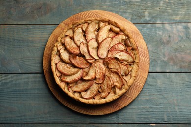 Delicious apple pie on light blue wooden table, top view