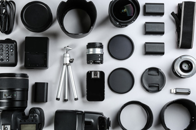 Photo of Flat lay composition with equipment for professional photographer on white background