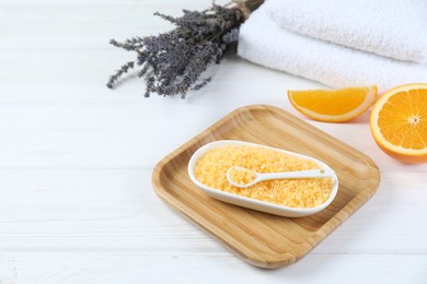 Sea salt, lavender, orange and towels on white wooden table. Space for text