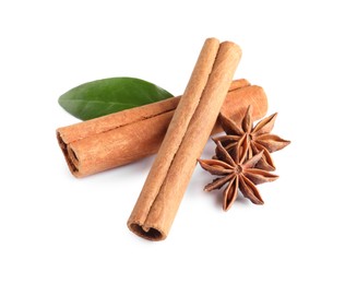 Photo of Cinnamon sticks, anise stars and green leaf isolated on white