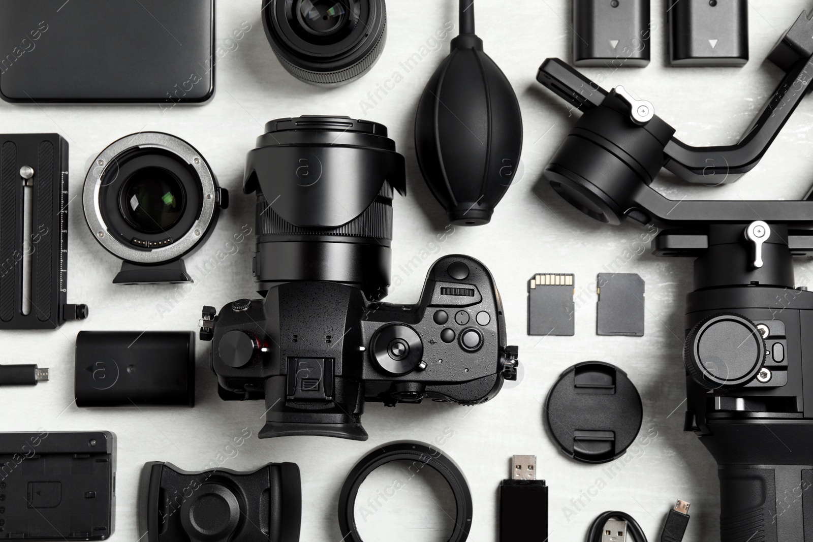 Photo of Flat lay composition with camera and video production equipment on light background