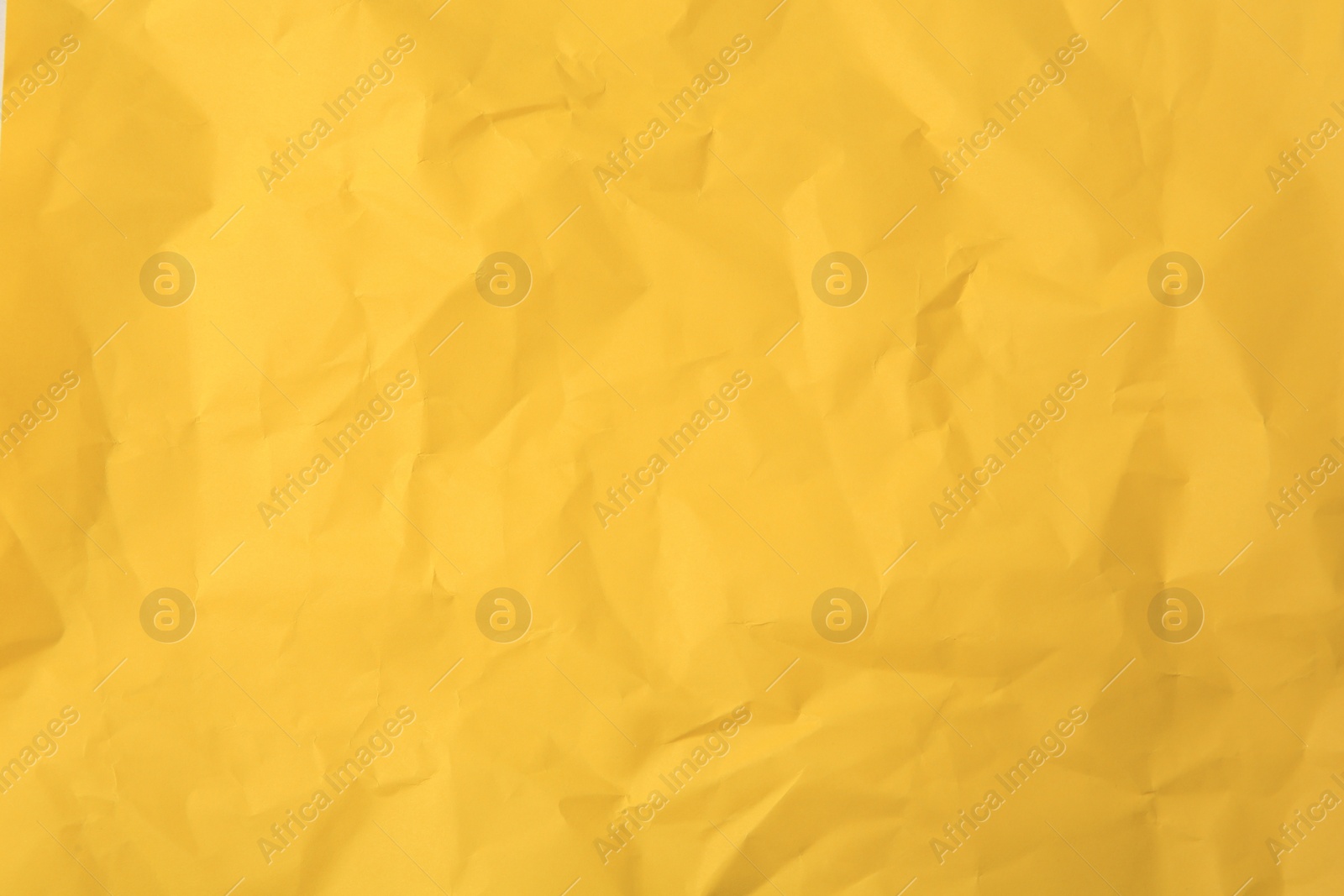 Photo of Sheet of crumpled orange paper as background, top view