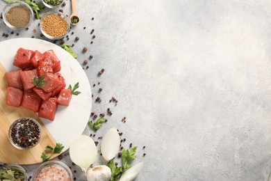 Photo of Raw beef meat and different ingredients for cooking delicious goulash on light grey table, flat lay. Space for text