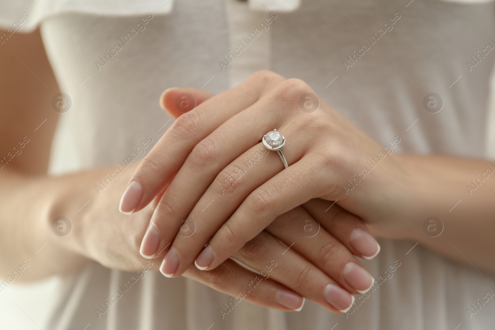 Photo of Young bride wearing beautiful engagement ring, closeup