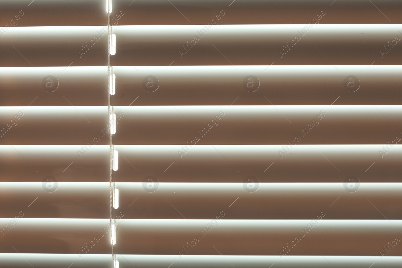 Photo of Closed modern white window blinds as background, closeup view