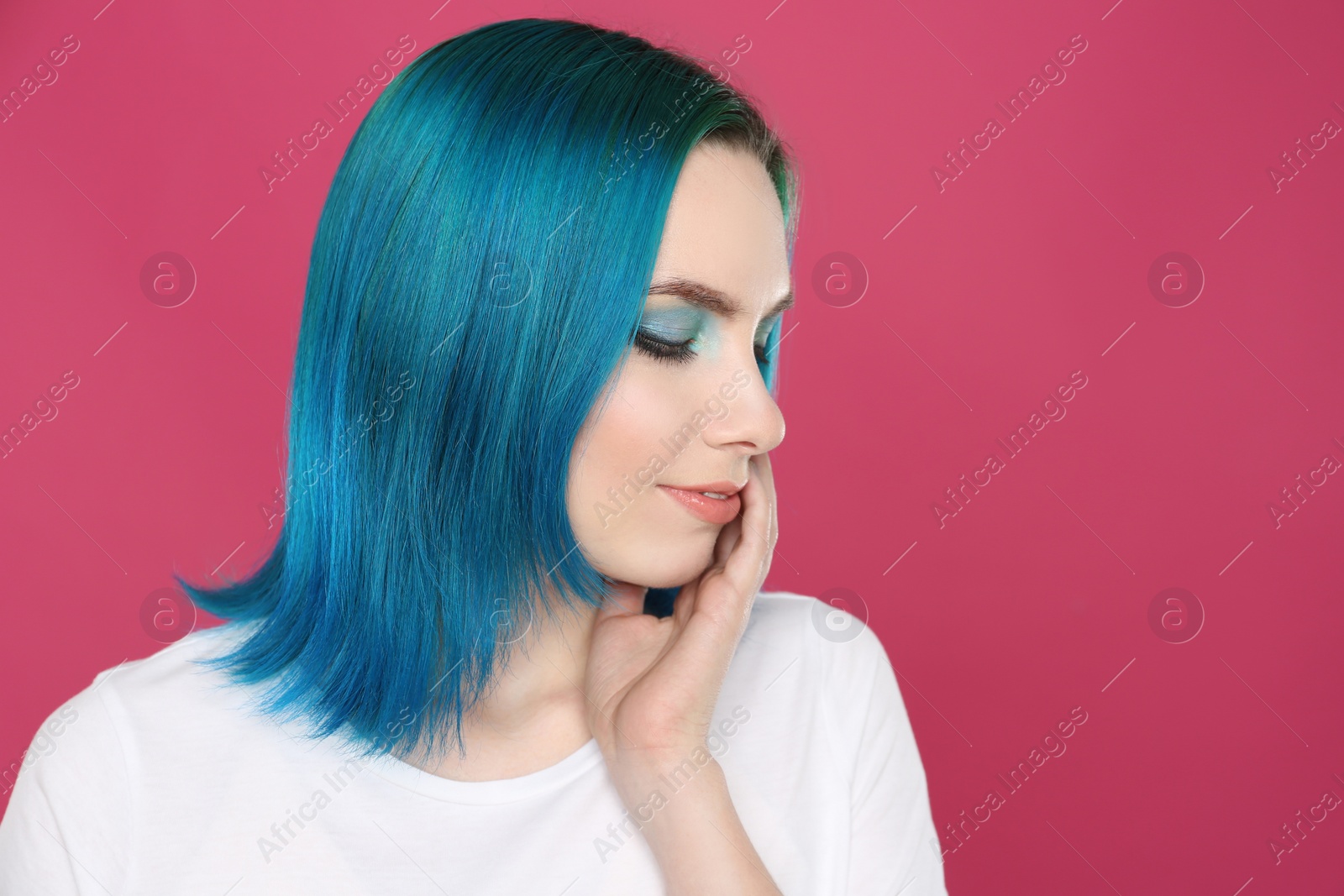 Photo of Young woman with bright dyed hair on pink background