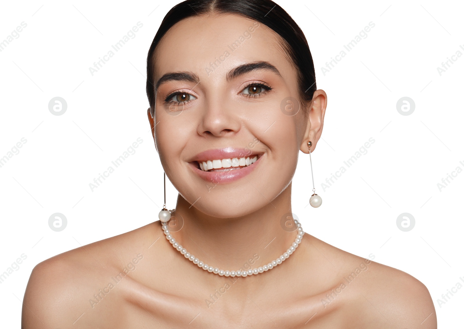 Photo of Young woman wearing elegant pearl jewelry on white background