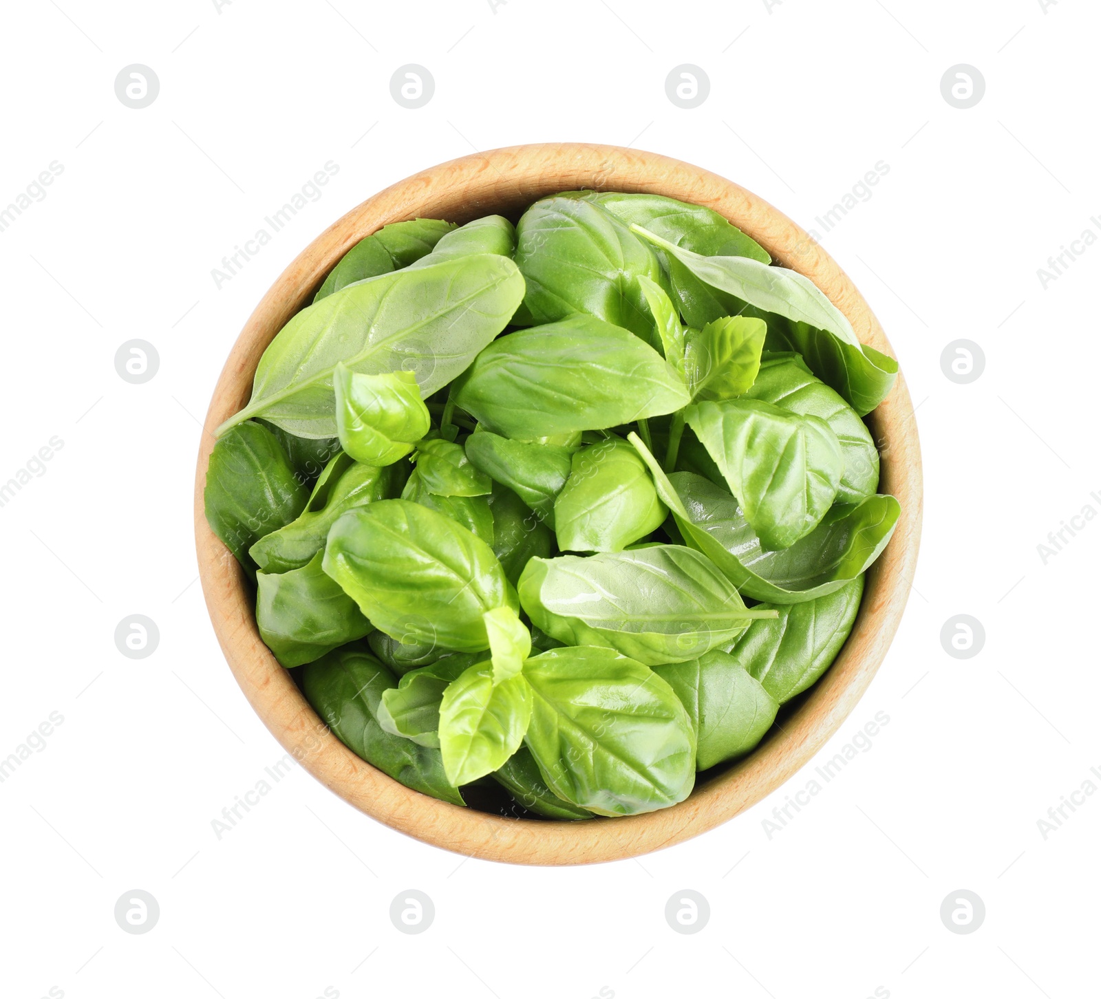 Photo of Fresh green basil leaves in wooden bowl isolated on white, top view